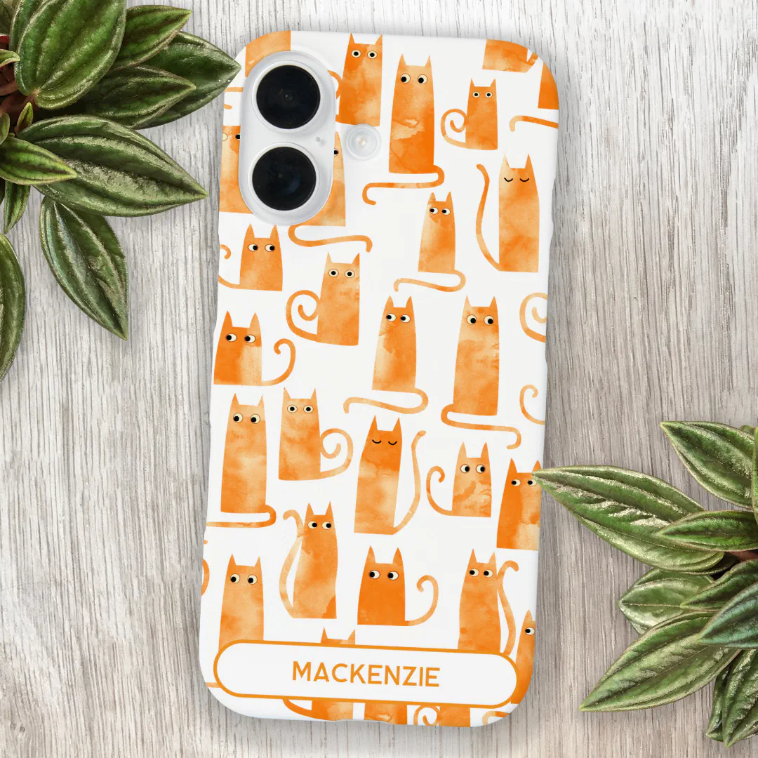 Custom iPhone case featuring playful orange tabby cat illustration on a background with leaves.