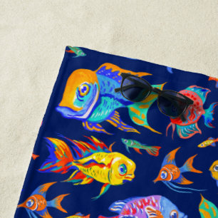 Fun tropical fishes on dark blue beach towel