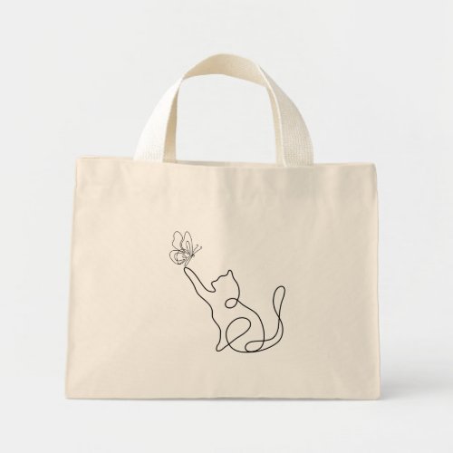 Funny cute little cat plays with a buuterfly mini tote bag