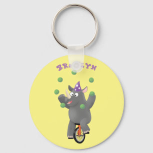 Funny cute rhino juggling on unicycle cartoon keychain