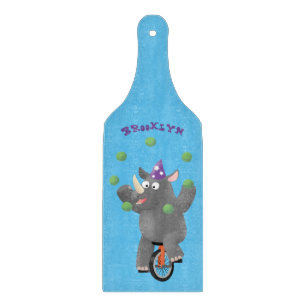 Funny cute rhino juggling on unicycle cutting board
