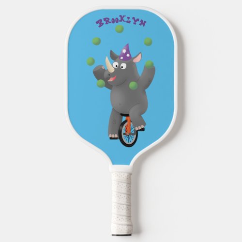 Funny cute rhino juggling on unicycle  pickleball paddle
