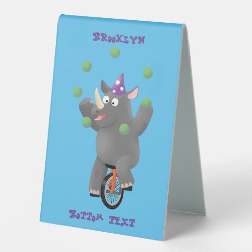 Funny cute rhino juggling on unicycle table tent sign