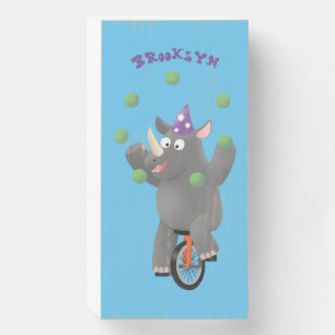 Funny cute rhino juggling on unicycle wooden box sign