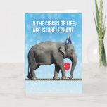 Funny Elephant Photo– Age Is Irrelephant Birthday Card<br><div class="desc">Funny photo of an elephant wearing a party hat,  holding a balloon with her trunk and walking on a tight rope. In the circus of life,  age is irrelephant,  Unless you're on a tight rope,  then it helps to be young. So true!</div>