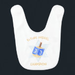 Funny "Future Dreidel Champion" Cute Hanukkah Baby Bib<br><div class="desc">Get ready to spin up some Hanukkah fun with this adorable “Future Dreidel Champion” baby bib. Featuring a playful blue dreidel illustration against a soft Star of David background, this charming design is perfect for celebrating your little one's first Festival of Lights. Ideal as a holiday gift or a photo-ready...</div>