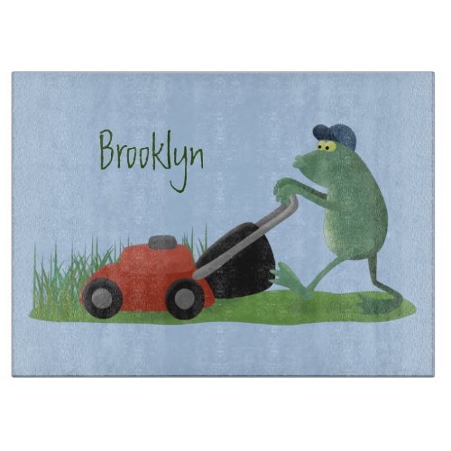 Funny green frog mowing lawn cartoon  cutting board