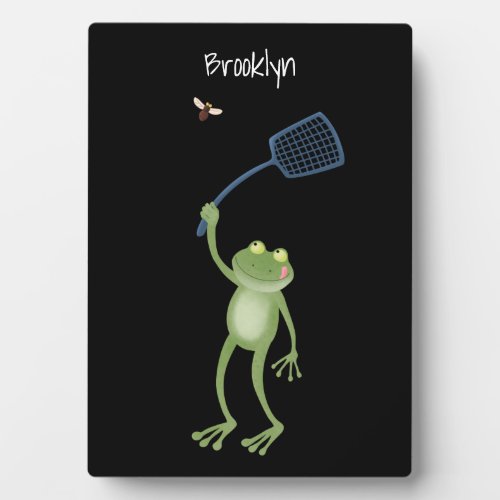 Funny green frog swatting fly cartoon plaque