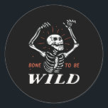 Funny Halloween Pun Skeleton Bone To Be Wild Classic Round Sticker<br><div class="desc">Bone to be wild. Funny haunting skull and skeleton design for your Happy Halloween party. Cool and awesome merchandise for those who love watching horror movies and going Trick or Treat on Halloween night. This goes well with your spooky and scary Halloween decoration of Jack-O-Lantern pumpkin, ghost, skull, skeleton, witches...</div>