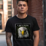 Funny I Am Smiling Grumpy Eagle Photo T-Shirt<br><div class="desc">This bold and funny t-shirt features a striking photo of a grumpy-looking bald eagle with the phrase "I AM SMILING" adding a touch of sarcastic wit. The combination of the eagle's fierce gaze and the ironic text creates a funny yet powerful statement. Ideal for casual wear or as a unique...</div>