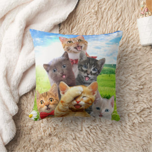 Funny kittens in green field. throw pillow