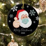 Funny Masked Santa Commemorative Christmas Ceramic Ornament<br><div class="desc">A commemorative christmas ornament to mark a year to remember! Featuring a masked Santa Claus with snowflakes,  'Merry Christmas' in calligraphy script text and the year. On the reverse you can personalize your xmas ornament with your family name.</div>