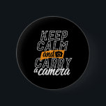 Funny Photographer Keep Calm and Carry A Camera Button<br><div class="desc">Keep Calm Carry A Camera. Vintage and retro photography design for photographers. Cool and funny merchandise for those who love taking photos, member of photography club. Perfect for amateur or professional photographers who carry cameras and lenses everywhere. Great Christmas gift and birthday present for brother, sister, mother, father, friends, aunt...</div>