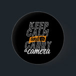 Funny Photographer Keep Calm and Carry A Camera Button<br><div class="desc">Keep Calm Carry A Camera. Vintage and retro photography design for photographers. Cool and funny merchandise for those who love taking photos, member of photography club. Perfect for amateur or professional photographers who carry cameras and lenses everywhere. Great Christmas gift and birthday present for brother, sister, mother, father, friends, aunt...</div>