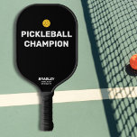 Funny Pickleball Champion Custom Text Name Paddle<br><div class="desc">Surely you know someone who deserves this funny pickleball paddle that reads "Pickleball Champion". Design features Bold White text that's set against a black background and is highlighted by a yellow pickleball (you can easily change the background color). Add 2 lines of custom text to personalize - club name, location,...</div>