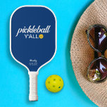 Funny Pickleball Y'all Custom Text Name Paddle<br><div class="desc">Hey Y'all, let's all play pickleball! This funny pickleball paddle reads "pickleball y'all" in a bold white text that's set against a blue background and highlighted by a yellow pickleball (you can easily change the background color). Add 2 lines of custom text to personalize - club name, location, player's name,...</div>