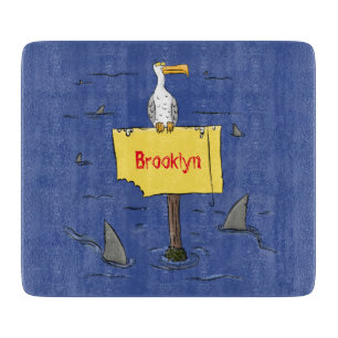 Funny sea bird circled by sharks cartoon cutting board