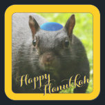 Funny Yarmulke-Wearing Squirrel • Happy Hanukkah Square Sticker<br><div class="desc">He may not look like he's in the mood to spread holiday cheer on the outside, but on the inside, Santa Squirrel's Jewish cousin, Hanukkah Squirrel, is as cheerful as any squirrel hunting holiday nuts you'll ever see! Delight your friends and share our friendly Hanukkah Squirrel with them on gifts,...</div>