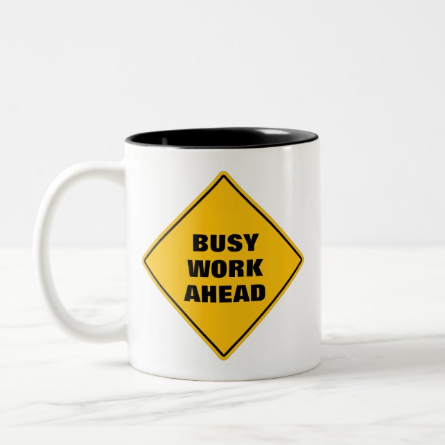 Funny yellow busy work ahead caution road sign Two Two-Tone Coffee Mug (Left)