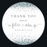 Future Mrs Blue Glitter Bridal Shower Thank You Classic Round Sticker<br><div class="desc">Future Mrs Blue Glitter Bridal Shower Thank You. The Future Mrs is in an artsy set script with ring and heart motifs and the rest of the text you can easily personalise. Glitter in shades of peacock blue decorates the top and bottom edges.</div>