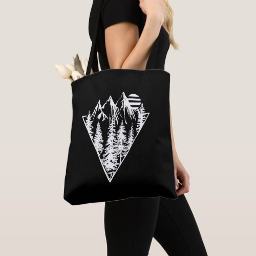 Geometric landscape of pine trees and mountain tote bag