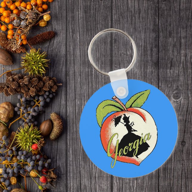 Georgia Peach Keychain (Southern bell lady silhouette on peach with Text Georgia on vibrant blue keychain.)