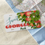 Georgia Peach License Plate<br><div class="desc">Peach with Flowers nestled in Green Leaves.
The "Customize Further",  button will aid you in any changes in regards to font style,  color,  text or graphic placement.</div>