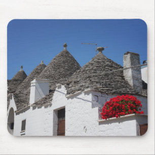 Geranium flowers and trulli houses in Alberobello Mouse Pad