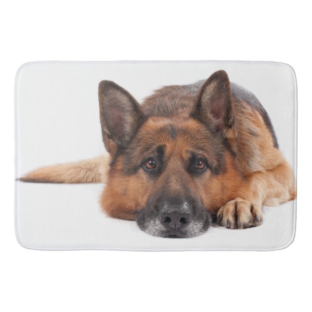 German shepherd lying down on a white background bath mat (Front)