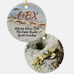 Ghost Crab OBX North Carolina Photographic Ceramic Ornament<br><div class="desc">This photographic OBX beach ceramic ornament features an Atlantic Ghost Crab and his burrow in the beach sand. The Atlantic Ghost Crab can be found all along the Atlantic coast. As is, it is a travel souvenir of The Outer Banks North Carolina or the text may be customized with your...</div>