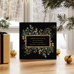 Gilded Greenery on Black | Christmas Holiday Photo Save The Date<br><div class="desc">This stunning Christmas wedding save the date features holiday greenery and leaves with faux gold leaves and red holly berries,  and a center gold frame on a modern black background. Your personal photo goes on the back,  surrounded by another gold geometric frame with winter greenery.</div>