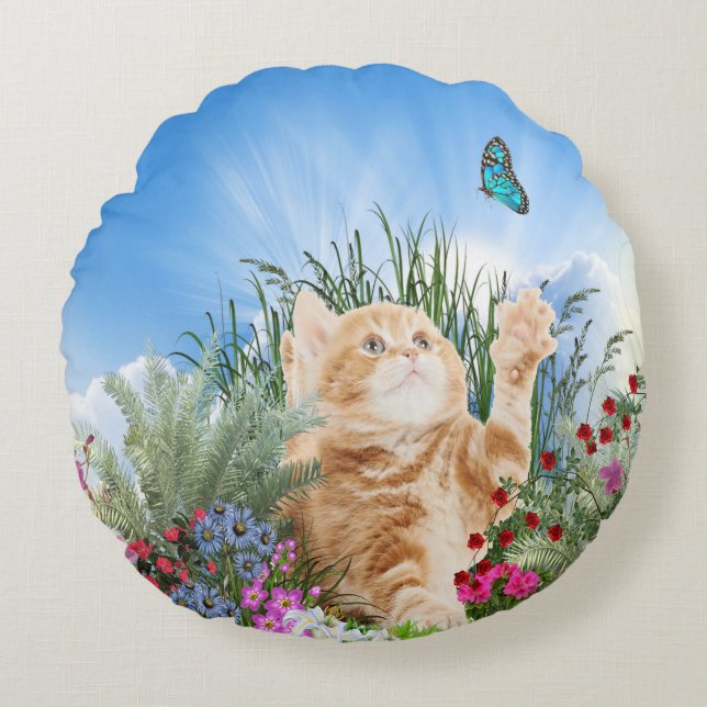 Ginger kitten playing with a butterfly round pillow (Front)