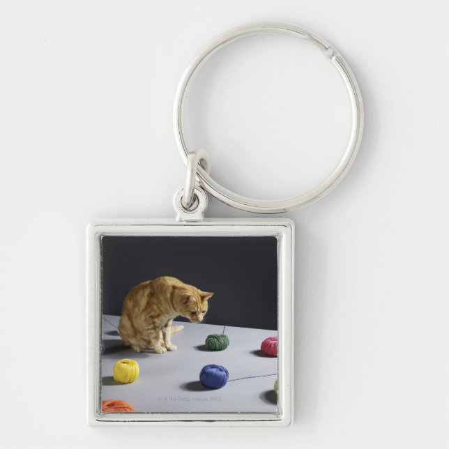 Ginger tabby cat sitting on table keychain (Front)