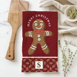 Gingerbread Man Red Monogram Merry Christmas Kitchen Towel<br><div class="desc">Celebrate the holiday season with this custom gingerbread man Merry Christmas kitchen towel. Featuring a cute gingerbread man with a red bow tie, a festive "Merry Christmas" greeting, and a personalized monogram on a red background, this towel adds a fun and festive touch to your kitchen decor. Perfect for gifting...</div>