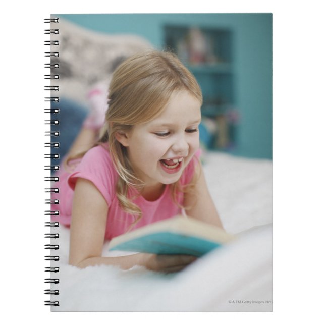 Girl laying in bed reading book (Front)