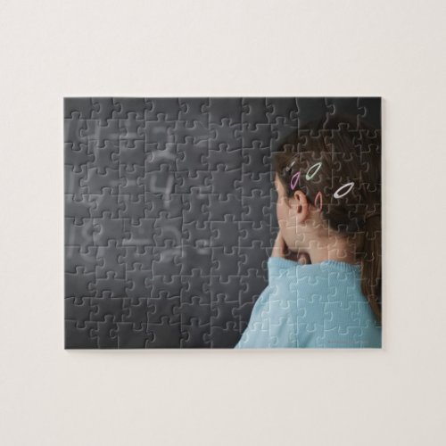 Girl looking at math equations on blackboard jigsaw puzzle