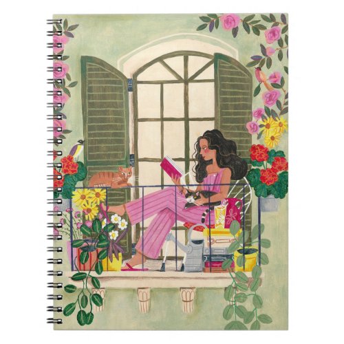 Girl reading on summer balcony with cats notebook