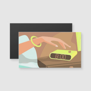 Girls hand pushing on alarm clock snooze button