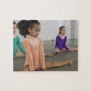 Girls stretching in gymnastics practice jigsaw puzzle