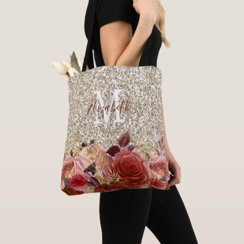 Girly Rose Gold Floral Monogram Light Gold Glitter Tote Bag - This tote bag features a sparkly glam design. This girly bag offers a custom monogram on a light gold faux glitter background accented with rose gold and peach flowers.