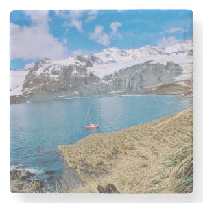 Glaciers and sailing yacht in background stone coaster