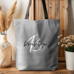 Glam Silver Brushed Metal Black White Monogram  Tote Bag<br><div class="desc">This elegant personalized tote bag features a monogram and first name in modern black and white script on a glam silver brushed metal background.</div>