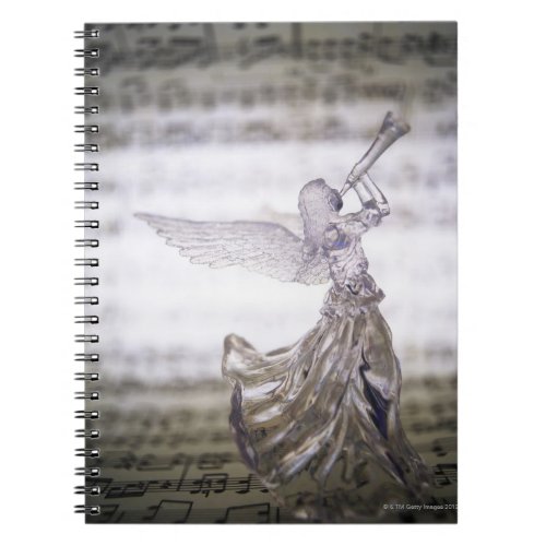 Glass angel playing trumpet and image of sheet notebook