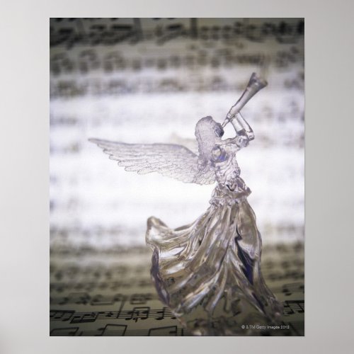 Glass angel playing trumpet and image of sheet poster
