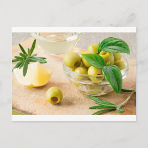 Glass cup with green pitted olives postcard
