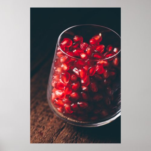 Glass full of red pomegranate seeds poster