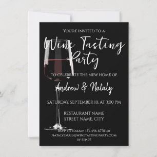 Glass of red wine on black invitation