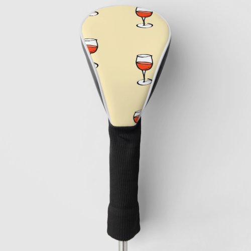 Glass of wine on orange golf head cover