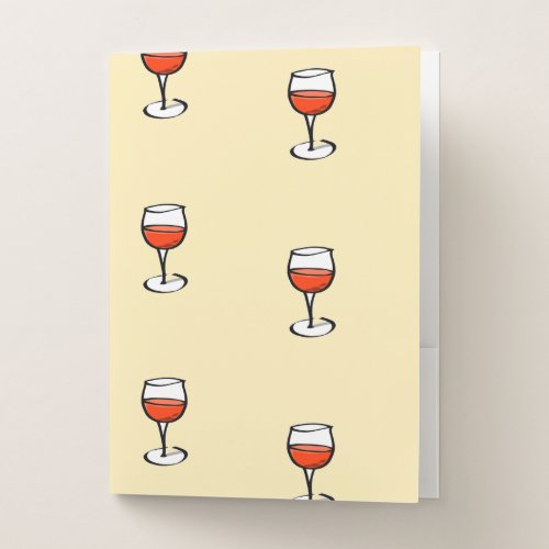 glass of wine on orange pocket folder