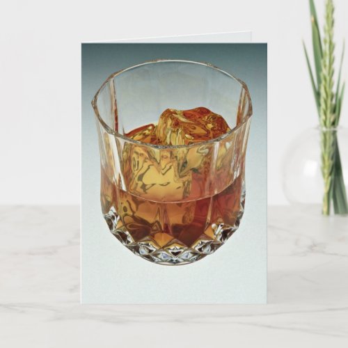 Glass tumbler filled with scotch and ice cubes card